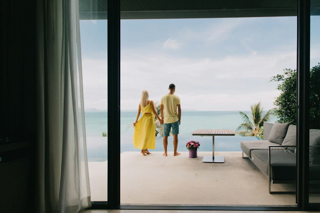 Traveling couple entering a luxury hotel